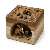 A burrow protected by a locked brass gate, with small beetles stuck outside